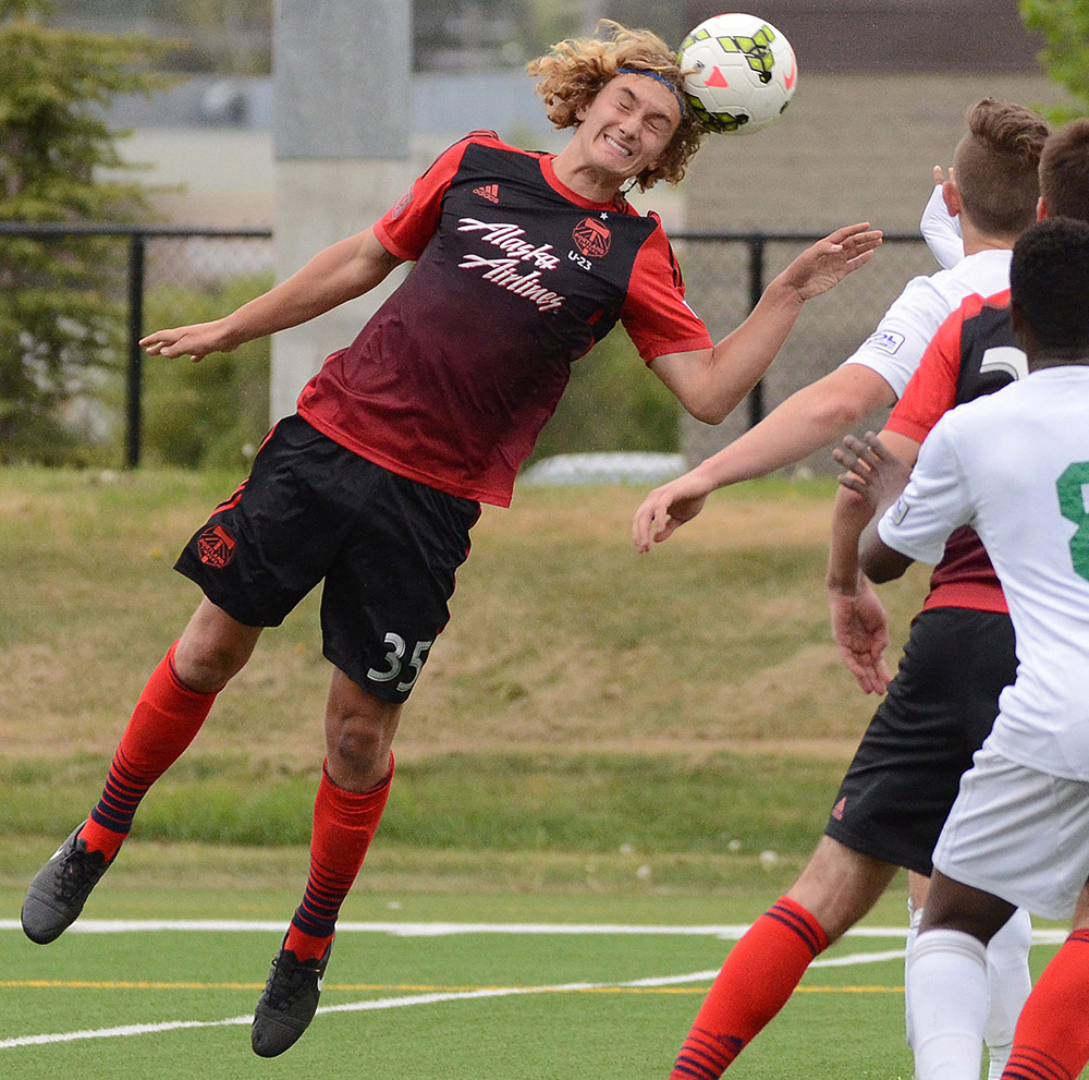 Portland Timbers U23's Kyle Adams stretches to head the ball against Calgary Foothills FC during their Premier Development League match at Hellard Field in Calgary Tuesday, June 2, 2015